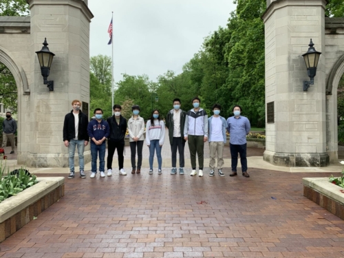 Ye research group from 2021 posing in front of IU's Sample Gates