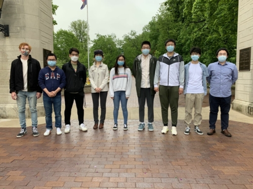 Ye research group from 2021 posing in front of IU's Sample Gates