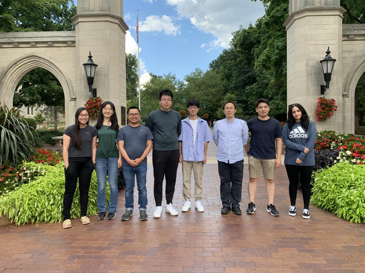 2022 members of the Ye research group posing in front of IU's Sample Gates